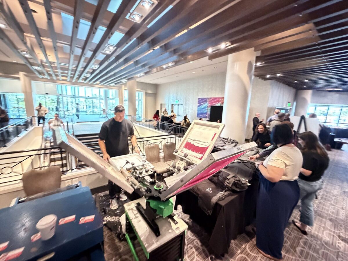 Merch Troop press line running live customization in a hotel conference lobby